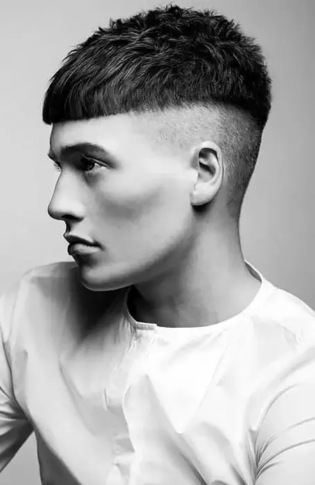 Crop haircut with a short length all around, creating a neat and low-maintenance look
