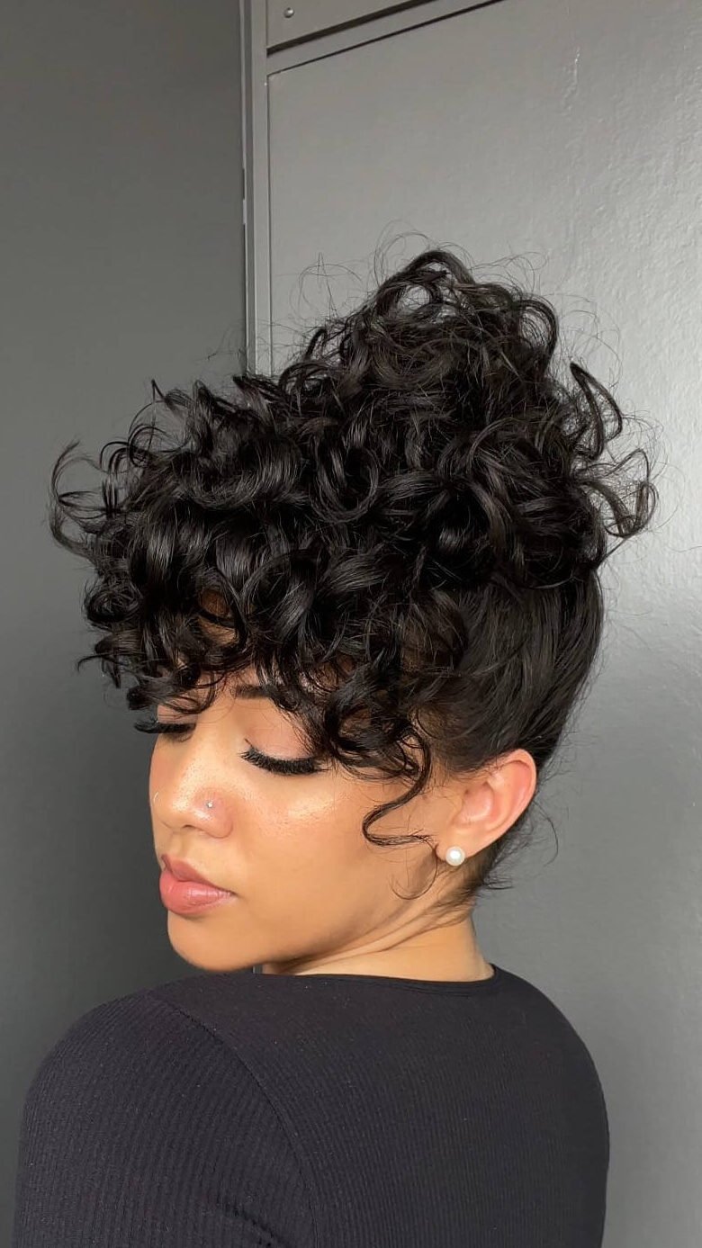 Curly updo with layered baby bangs
